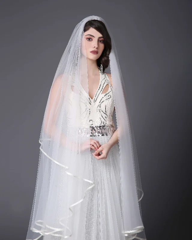 Knee-length veil with finishing tape. Long Sleeve Gown